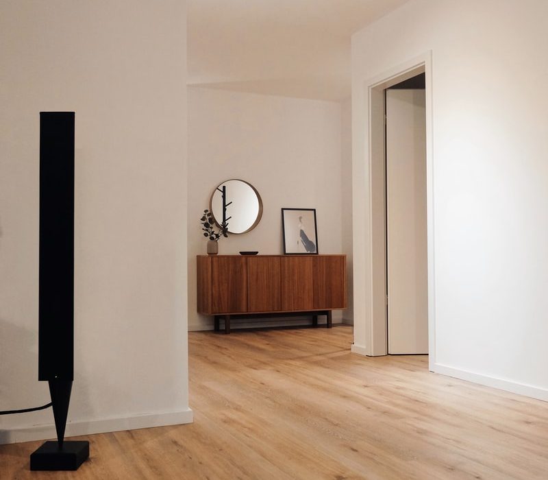 black tower speaker beside white wall